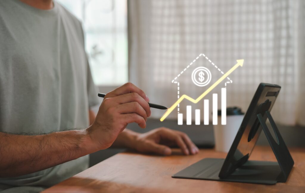 Person researching mortgage interest rates on a laptop with financial documents