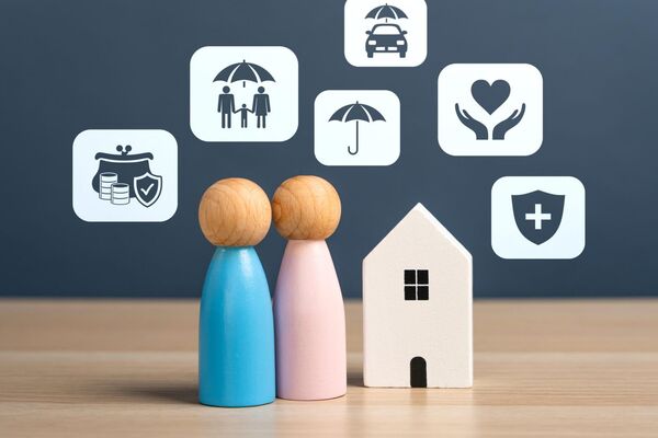 Miniature figures of a couple next to a model house